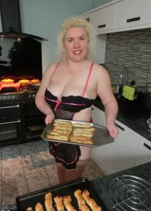 Aged blonde Barby removes lingerie to get naked in tan stockings while cooking