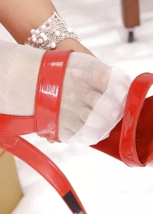 Hot blonde with nice tits in stockings and heels under the Christmas tree