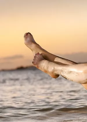 Симпатичная красотка порнозвезда демонстрирует красивую попку и киску на пляже