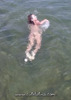 Latina amateur Talia uncovers her large tits while getting naked on a boat