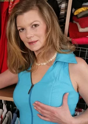 Грудастая темноволосая деловая женщина позирует на своем столе в сексуальном нижнем белье на каблуках