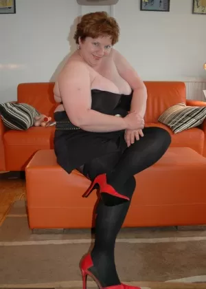 Redhead fatty Chris 44g bares a large boob before freeing her cunt from hose