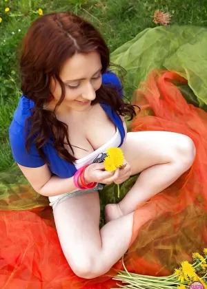 Young redhead Diana unveiling big natural tits outdoors by swimming pool