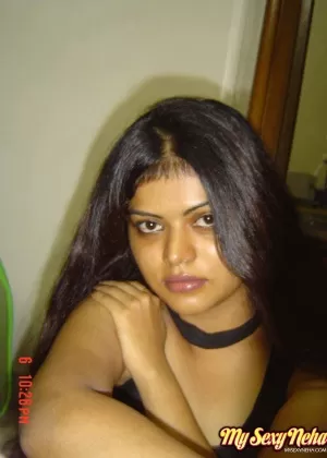 Indian woman Neha takes self shots while she holds her face firm