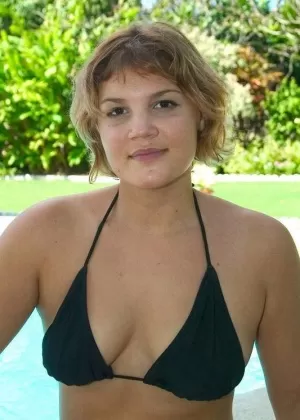 Teen amateur Lisa slips a finger in her pink pussy on a poolside patio