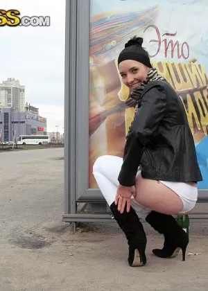 Brunette girl models naked in hosiery before exposing her ass crack in public