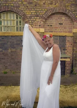 Blonde granny Savana models non nude in a long white gown