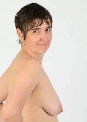 Short haired woman Hot MILF slips cotton underwear over her ass to get naked