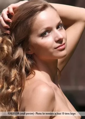 Totally naked girl shows off her beautiful body in a horse pasture